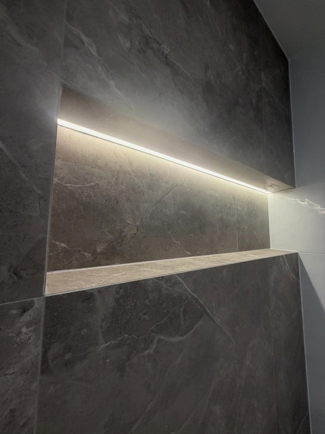 Tiled shower niche with concealed lighting